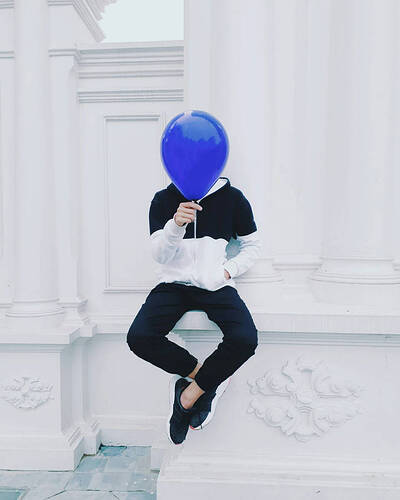 man-holding-blue-balloon-y5led9ja5e68s8sa